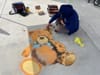 Photo of local Riverside artist coloring a realistic chalk drawing